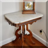 F39. Eastlake marble top side table. 29”h x 25”w x 19”d 